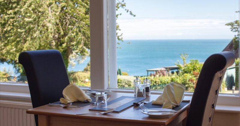 A table laid by the window with a sea view