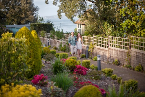 A couple walking through the clifftop gardens