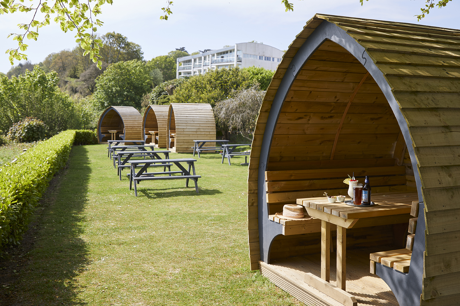 Covered garden dining pods looking out to sea